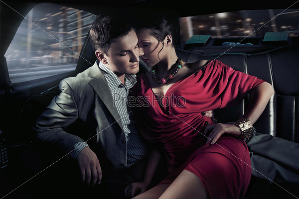Sexy sitting couple in car