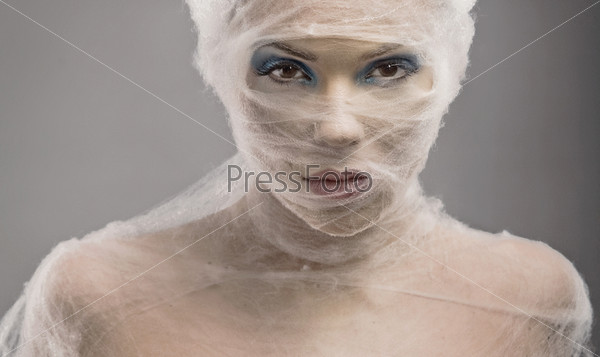 Woman with bandage wrapped around face