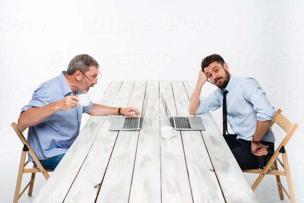 The two colleagues working together at office on gray background