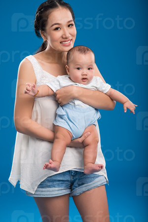 Beautiful smiling Vietnamese woman holding her baby boy