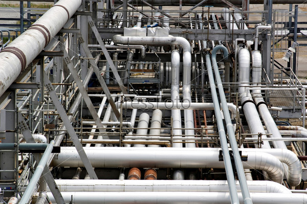 Industrial pipes flowing in various directions at an oil and gas refinery