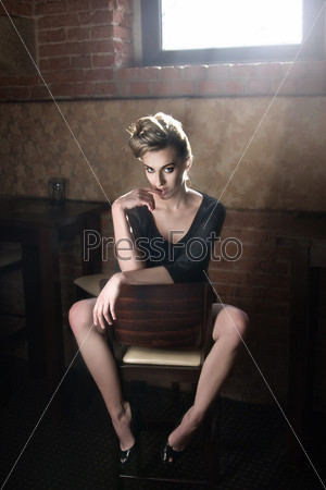 Gorgeous blonde sitting on a chair
