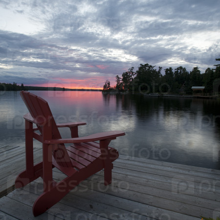 Chair on the dock at sunset in Lake of the Woods, Ontario