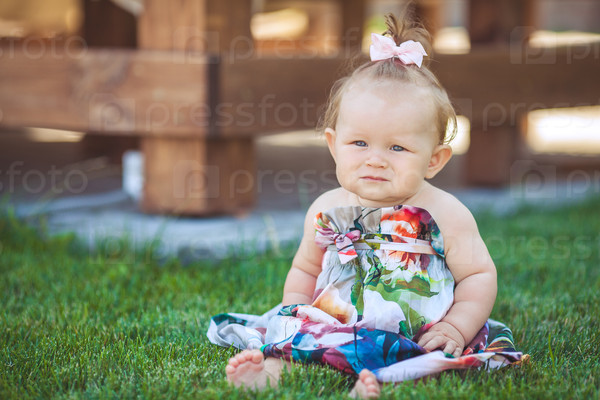 Portrait of adorable infant smiling girl in summer outdoor