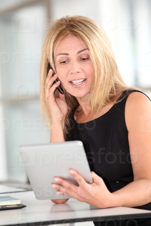 Businesswoman in the office with electronic tab