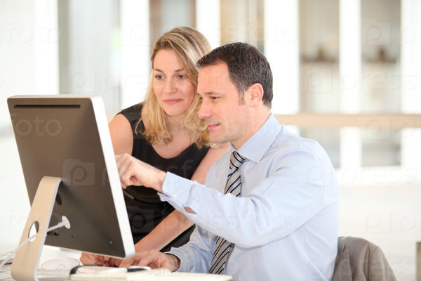 Office workers in front of computer