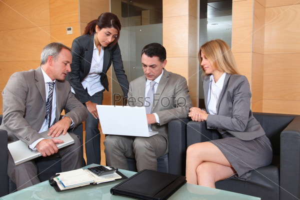 Group of associates meeting in lounge, stock photo