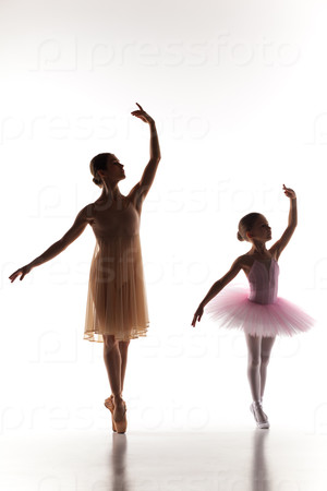 Stock Photo: The little ballerina dancing with personal ballet teacher in dance studio
