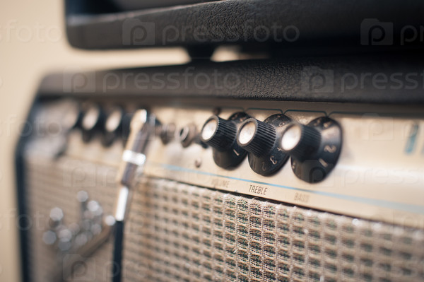 Guitar amplifier knobs detail in studio with selective focus on knobs