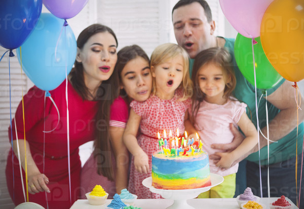 Portrait of a family celebrating birthday of their little daughter