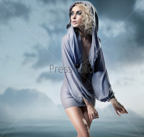 Glamour woman posing over blue background