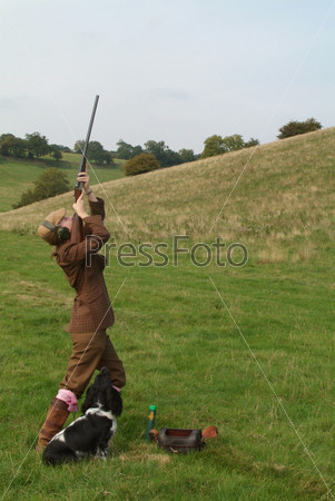 A woman shooting upwards, hunting, hunter