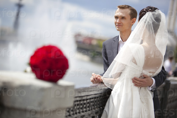 Young couple wedding. Looking to the river.