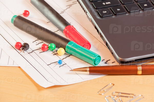 Laptop, pen and office supplies on office desk