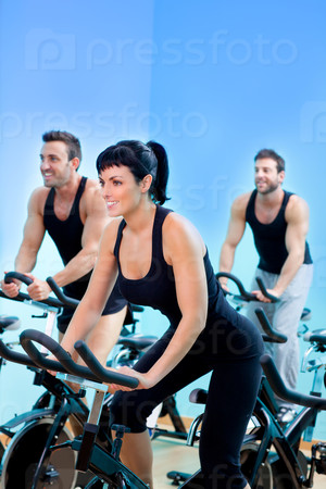 Stationary bicycles fitness girl in a gym sport club