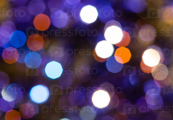 abstract blurred background - dark blue and violet flickering Christmas lights bokeh of electric garlands on Xmas tree