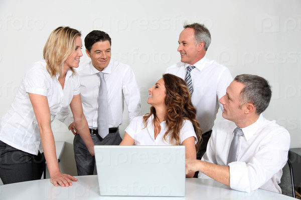 Group of office workers in front of laptop computer