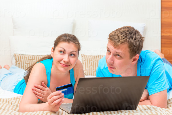 dreamy happy couple with a credit card to shop online