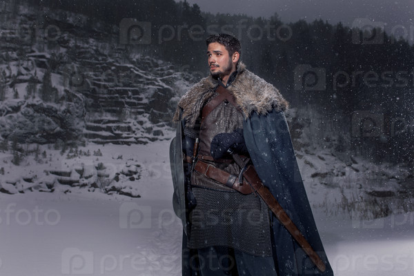 Medieval knight with sword in armor as style Game of Thrones in Winter Rock Landscapes