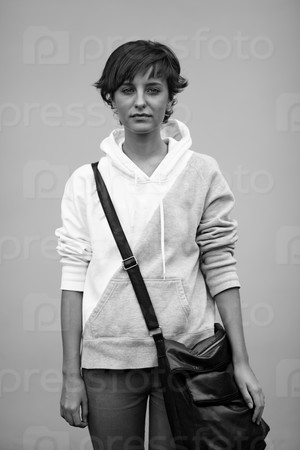 Sad teen with black bag, soft natural light ,selective focus on face, stock photo