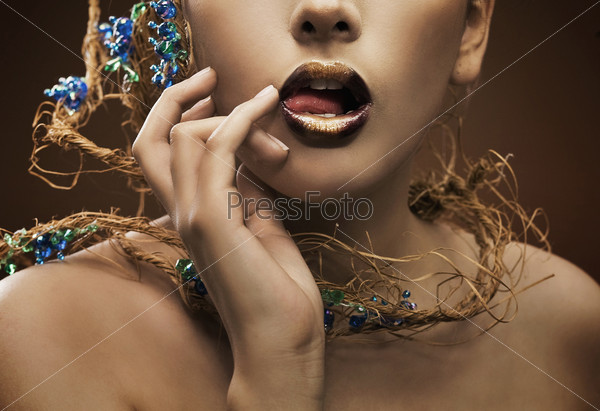 Hand and lips of a perfect young beauty