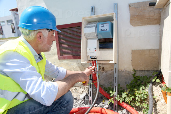 Electrical engineer on building site, stock photo