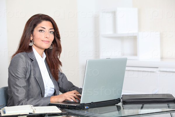 Closeup of smiling real estate agent in office