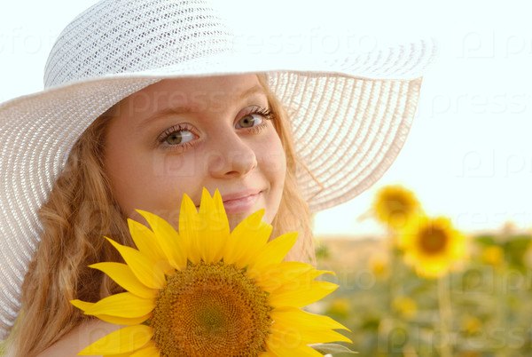 Beautiful young woman with sunflower