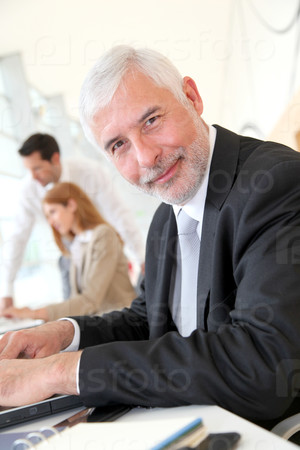 Senior businessman working on laptop computer