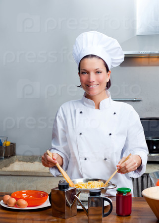 Chef woman portrait with white uniform in the kitchen