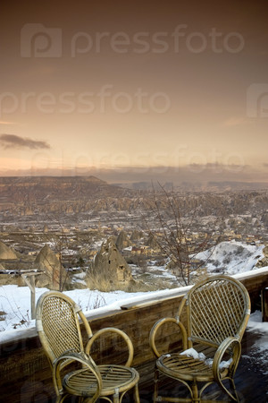 chairs set to view the beautiful landscape of Goreme, Cappadocia, Turkey during the freezing winter months.