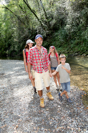 Family crossing a river