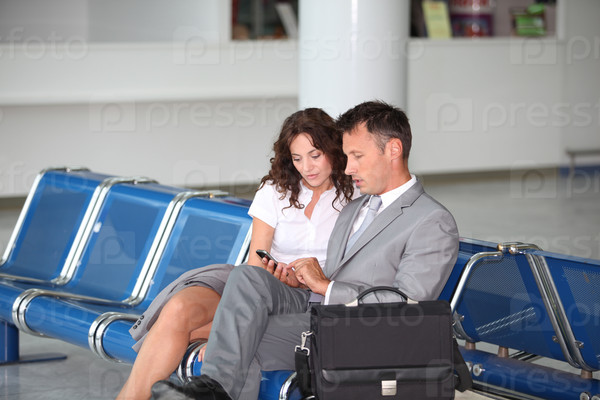 Business couple waiting at airport lounge