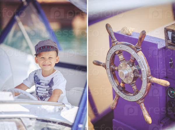 Cute little sailor boy having fan near boats on pier near the sea. Outdoor.