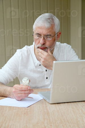 Senior man checking medical information on internet
