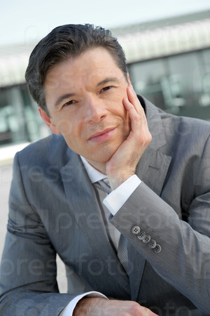 Portrait of businessman standing outside the office