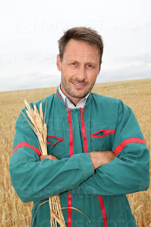 Portrait of happy farmer in wheat field