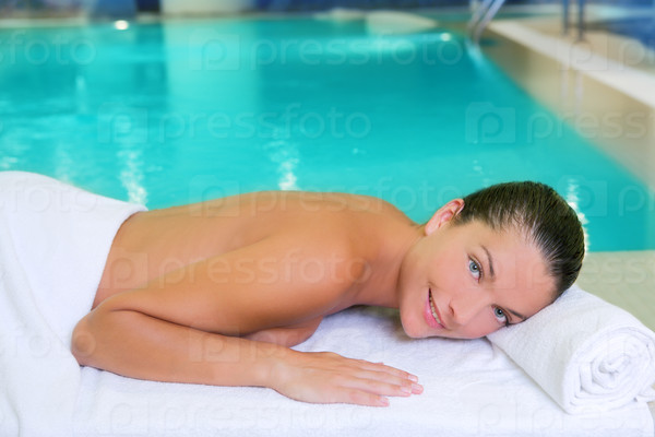spa pool woman relaxed on white towel near water