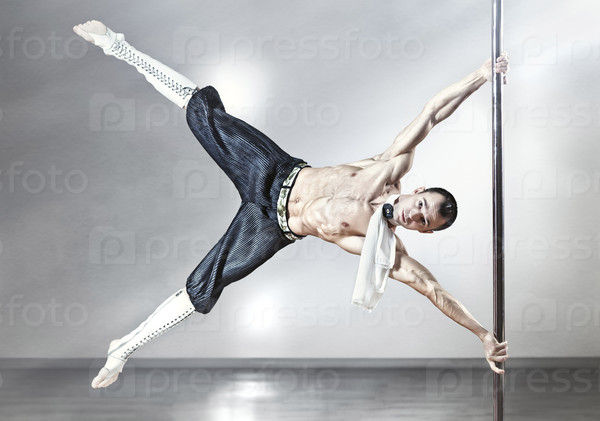 Young strong pole dance man.