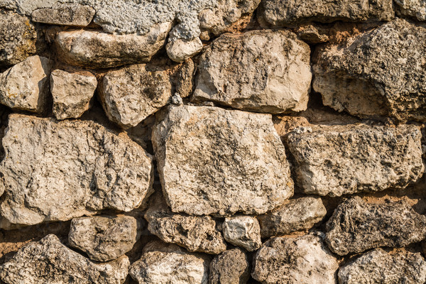 View of a natural stone wall built with clay mortar