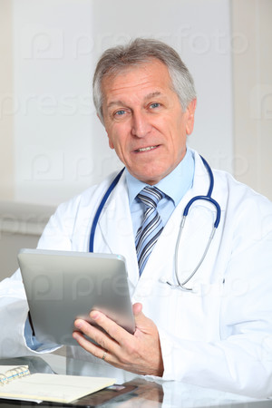 Closeup of doctor in the office with electronic pad