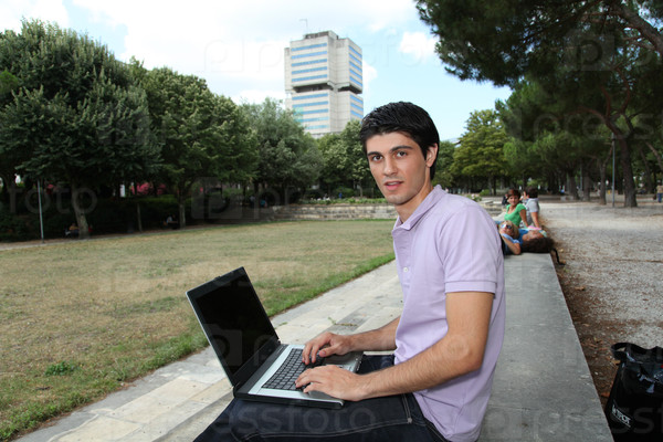 Student with laptop computer in college park