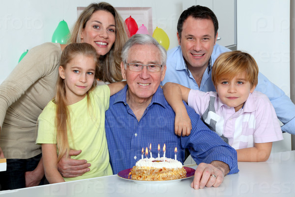 Family celebrating grandfather\'s birthday
