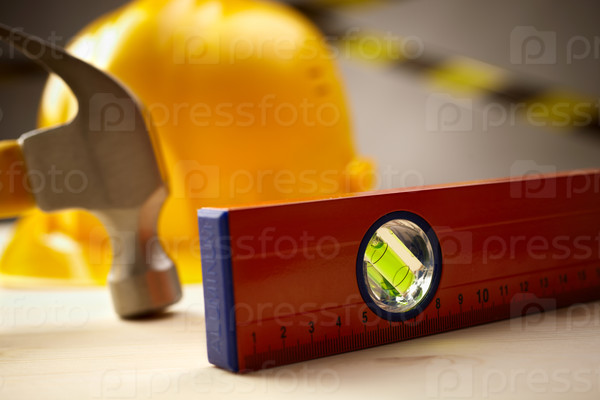 Industrial concept with level,hammer and yellow hardhat, selective focus, stock photo