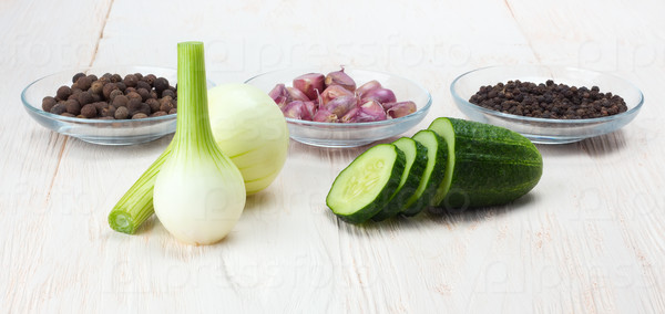 young white onions and cucumber on a wooden table