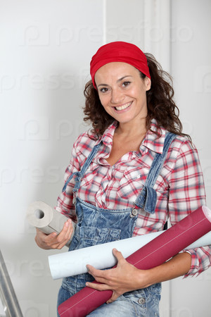 Woman holding wallpaper rolls for the house