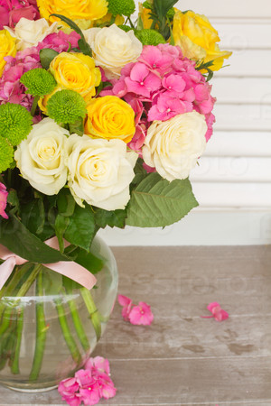 pink hortensia flowers with white and yellow roses in vase  close up