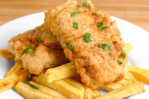 Fried fish and chips on the white plate