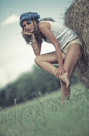 Young woman in a summer field. Calm pensive mood.