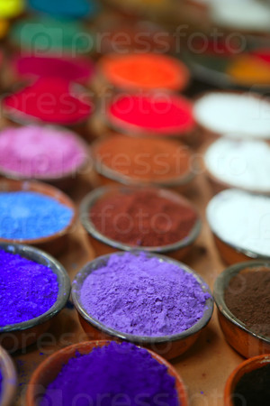 colorful powder pigments in rows in clay bowls